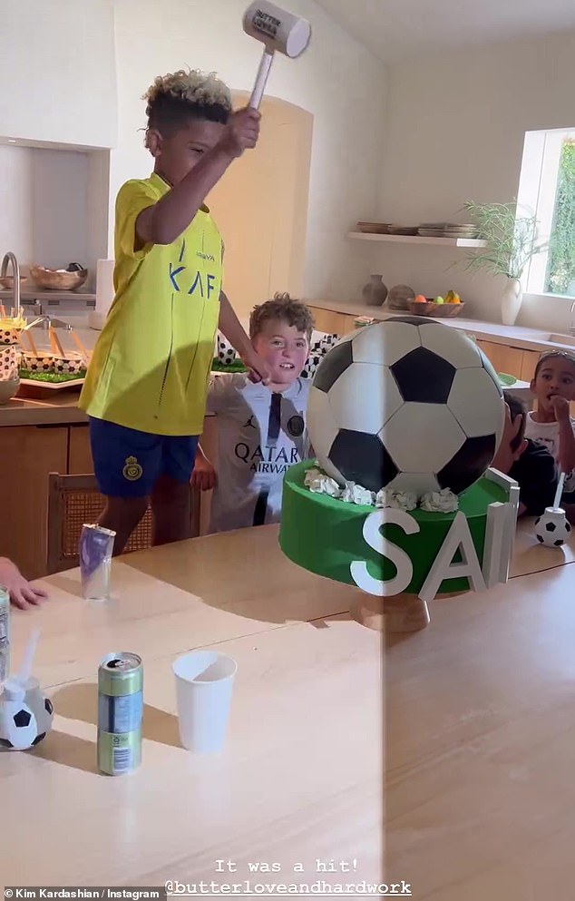 The kids gathered excitedly to watch the birthday boy break into the 'cake'