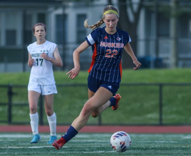 Naperville North's Claire DeCook (22) dribbles down field during the Class 3A East Aurora Regional championship game against Waubonsie Valley in Aurora on Friday May 17, 2024. (Troy Stolt/for the Naperville Sun)
