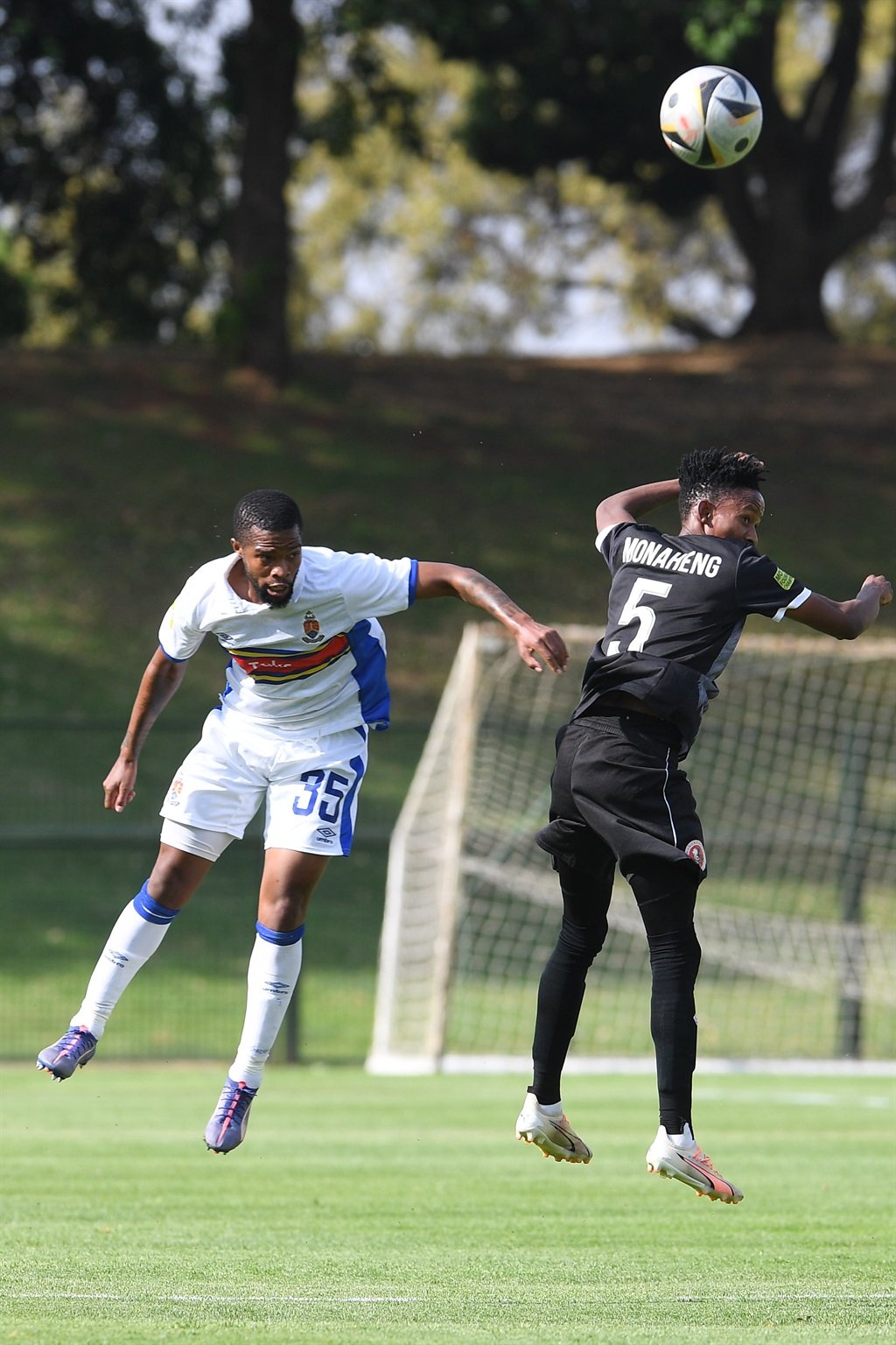 PRETORIA, SOUTH AFRICA - OCTOBER 27: Morena of Hungry Lions FC is challenge by Siyanda Msani Monaheng of Pretoria University FC during the Motsepe Foundation Championship match between Pretoria University FC and Hungry Lions FC at Tuks Stadium on October 27, 2024 in Pretoria, South Africa. (Photo by Lefty Shivambu/Gallo Images)