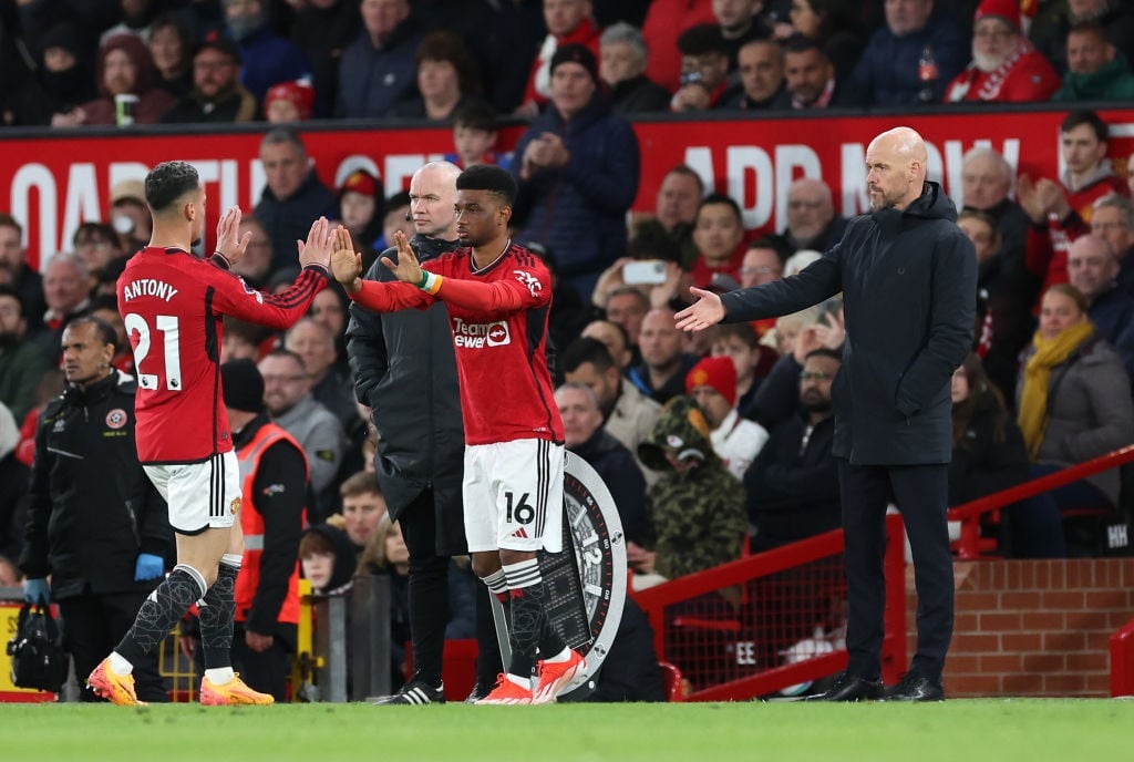 MANCHESTER, ENGLAND - APRIL 24: Amad Diallo of Manchester United enters the pitch as a substitute to replace team mate Antony as Erik ten Hag, Manager of Manchester United, looks on during the Premier League match between Manchester United and Sheffield United at Old Trafford on April 24, 2024 in Manchester, England. (Photo by Alex Livesey/Getty Images)