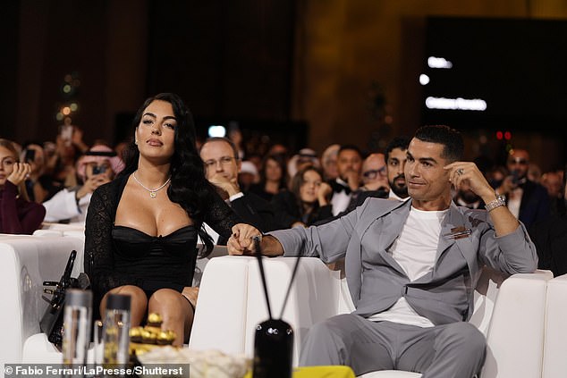 The pair beamed at each other as they took their seats at the event