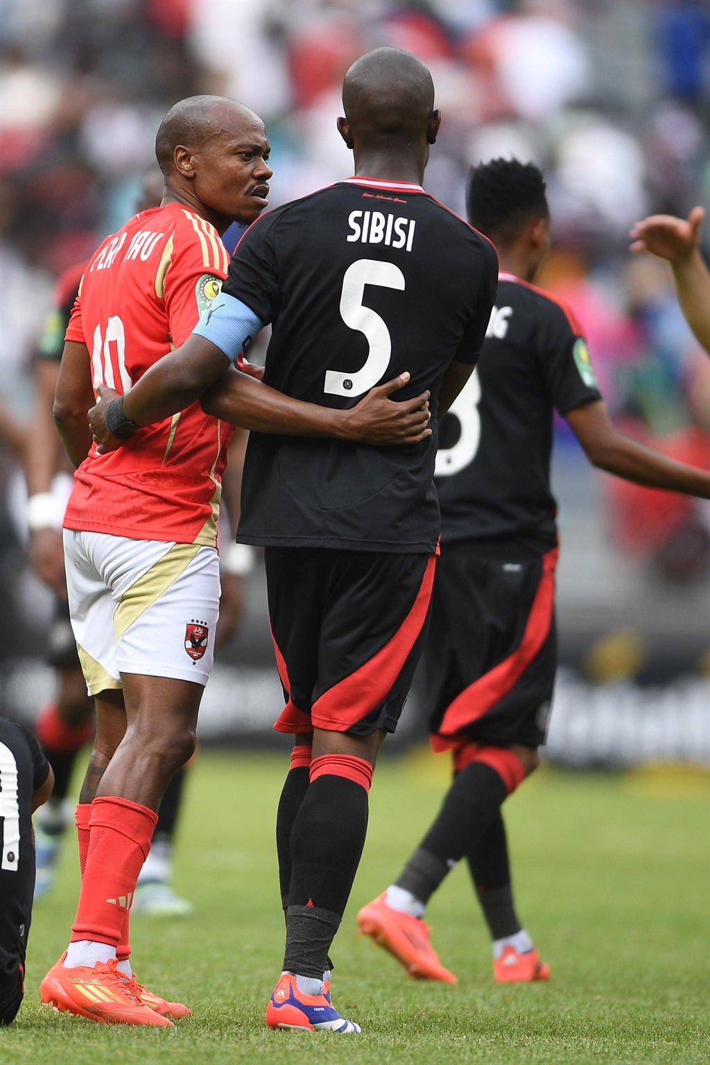 JOHANNESBURG, SOUTH AFRICA - DECEMBER 07: Percy Tau of AL Ahly FC with  Nkosinathi Sibisi during the CAF Champions League match between Orlando Pirates and Al Ahly SC at Orlando Stadium on December 07, 2024 in Johannesburg, South Africa. (Photo by Lefty Shivambu/Gallo Images)