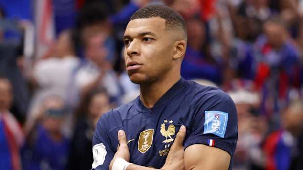 Kylian Mbappe celebrates after scoring a goal against Argentina on a penalty kick for his third goal of the match.