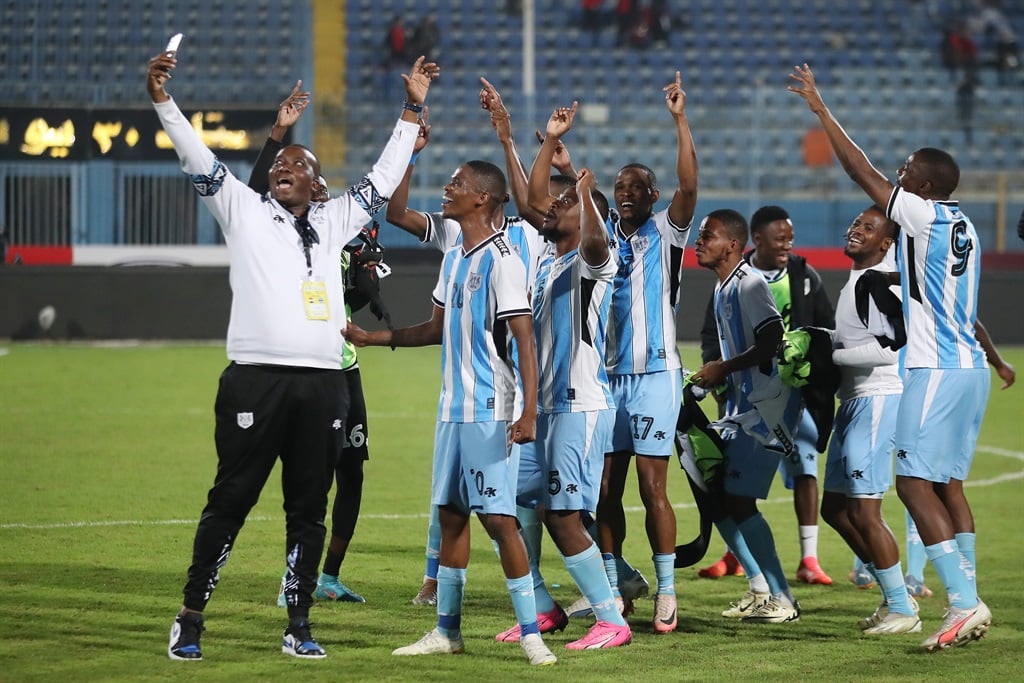 Botswana head coach Morena Ramoreboli celebrates with players after guiding the Zebras to qualification to the Afcon in Morocco.