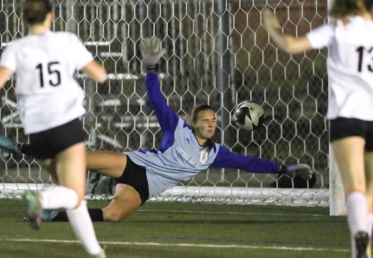 Corona del Mar goalie November Firey dives to stop a goal during Thursday's match.