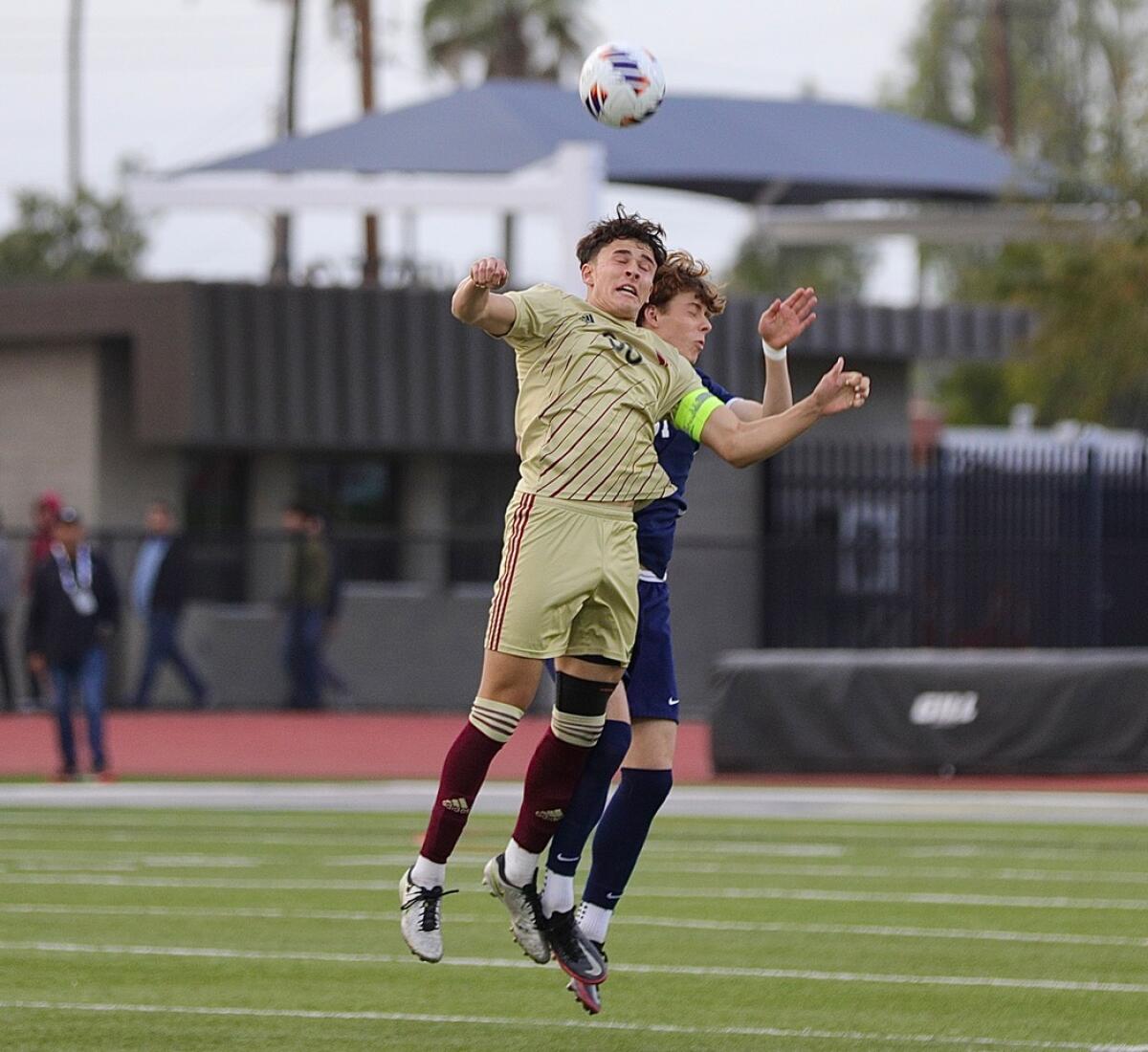 JSerra's Gavin Allegaert heads the ball away from Loyola’s Jack Nixon.