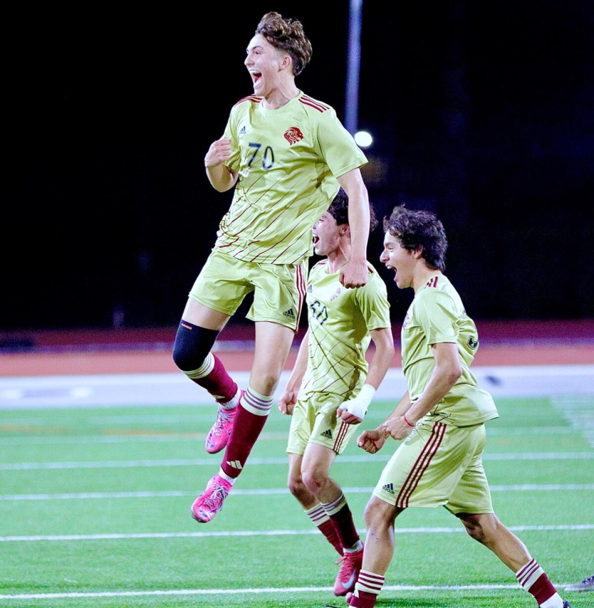 Tanner Casey, top, and his teammates celebrate JSerra’s 2-0 victory.